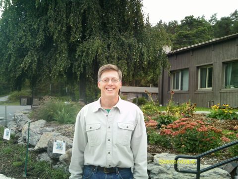 A picture of PEEC's new CEO in front of the Main Education building