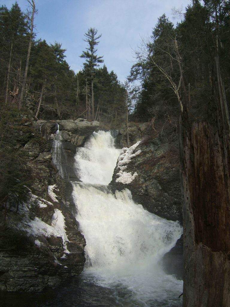 A narrow waterfall with several levels of cascades