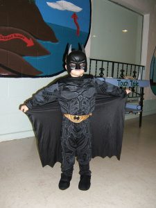 A young boy in a Batman costume and mask